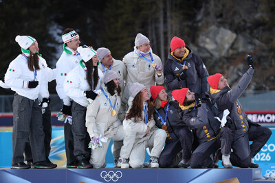 (Above) ANTHOLZ-ANTERSELVA, ITALY - FEBRUARY 08: Bronze medalist Justus Strelow, Philipp Nawrath, Vanessa Voigt and Franziska Preuss of Team Germany take a victory selfie with Gold medalists Eric Perrot, Quentin Fillon Maillet, Lou Jeanmonnot and Julia Simon of Team France during the medal ceremony for the Mixed Relay 4 x 6km (M+W) on day two of the Milano Cortina 2026 Winter Olympic games at Anterselva Biathlon Arena on February 08, 2026 in Antholz-Anterselva, Italy. (Photo by Alexander Hassens